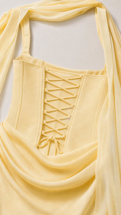 Close-up detail of lace-up corset back and waist drape on pastel yellow gown