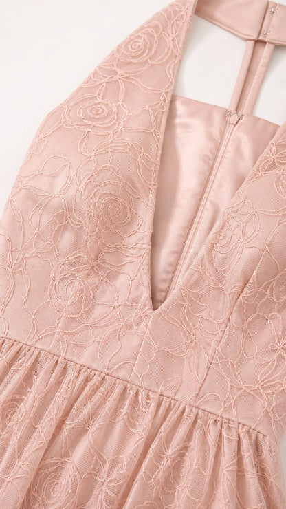 Close-up detail of floral lace pattern and halter neckline in blush pink