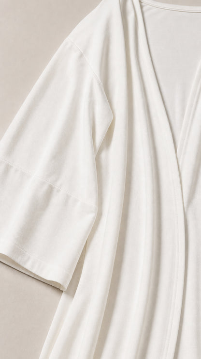 Close-up of smooth, lightweight white jersey fabric on cardigan and top