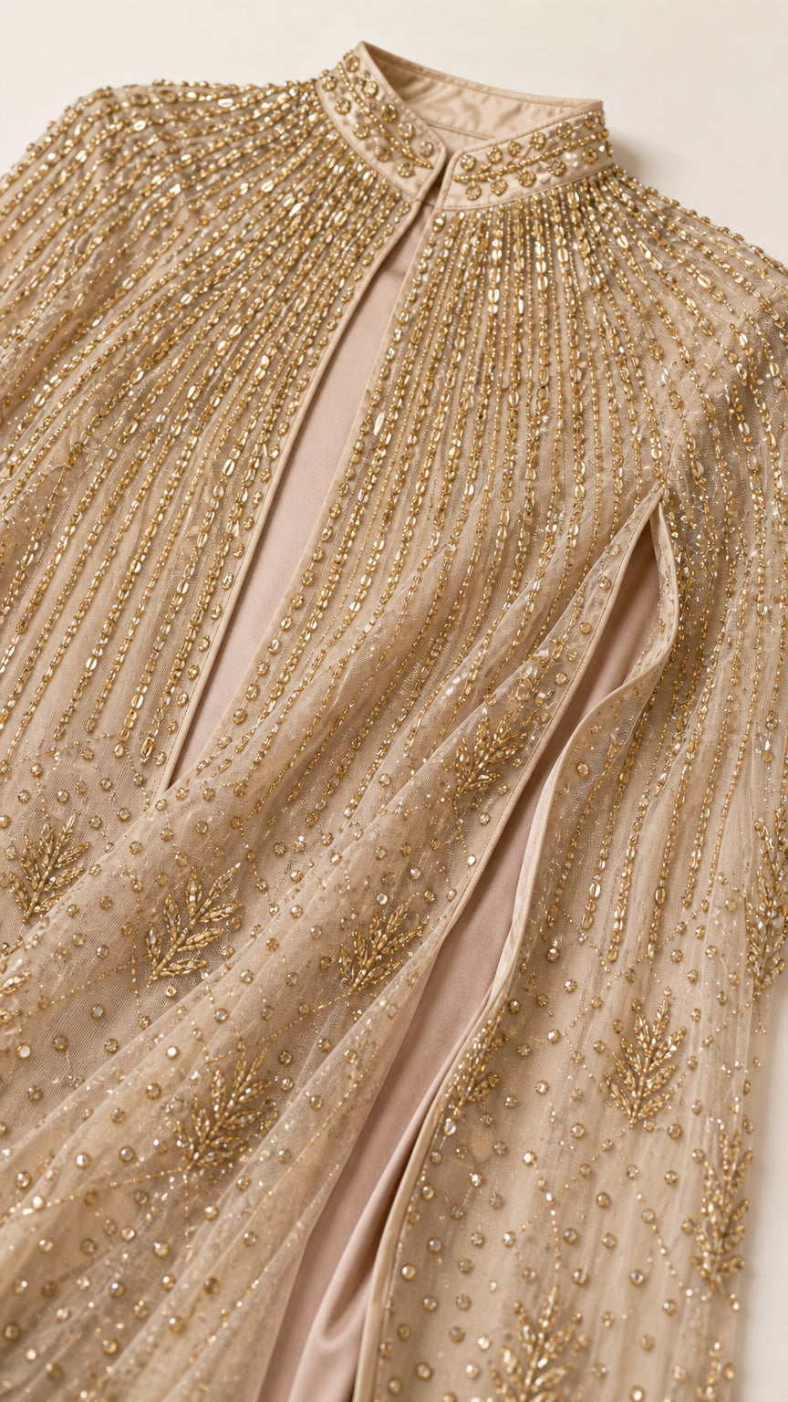Close-up detail of stand collar and linear sequin beading on champagne gold cape dress