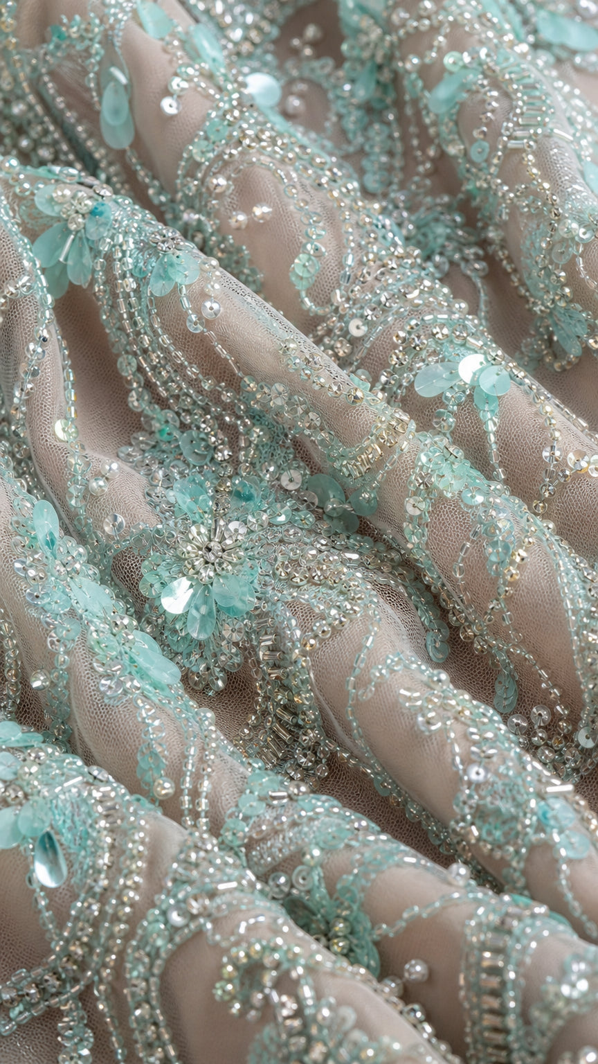 Close-up detail of intricate beading and sequins on mesh fabric