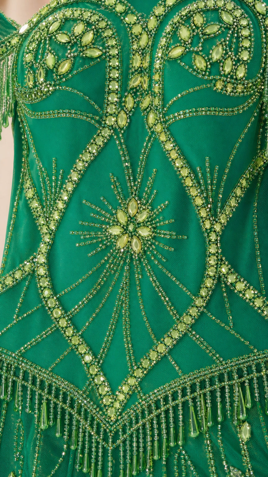 Close-up detail of the intricate green beadwork and crystal embellishments on the dress bodice