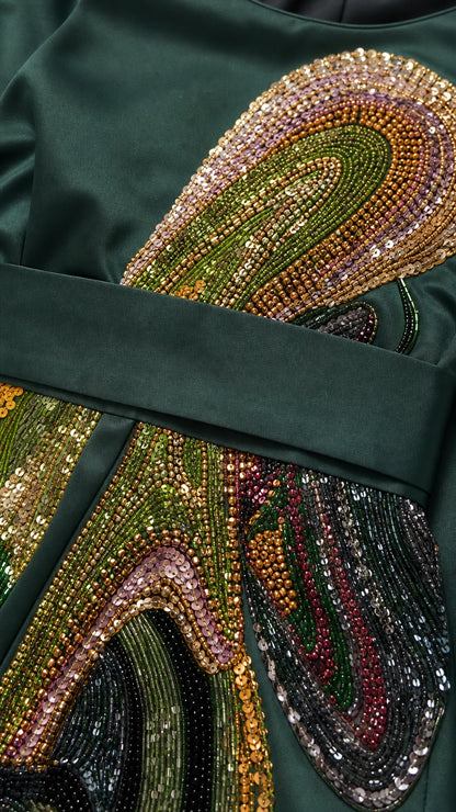 Close-up of intricate sequin and bead embroidery on satin