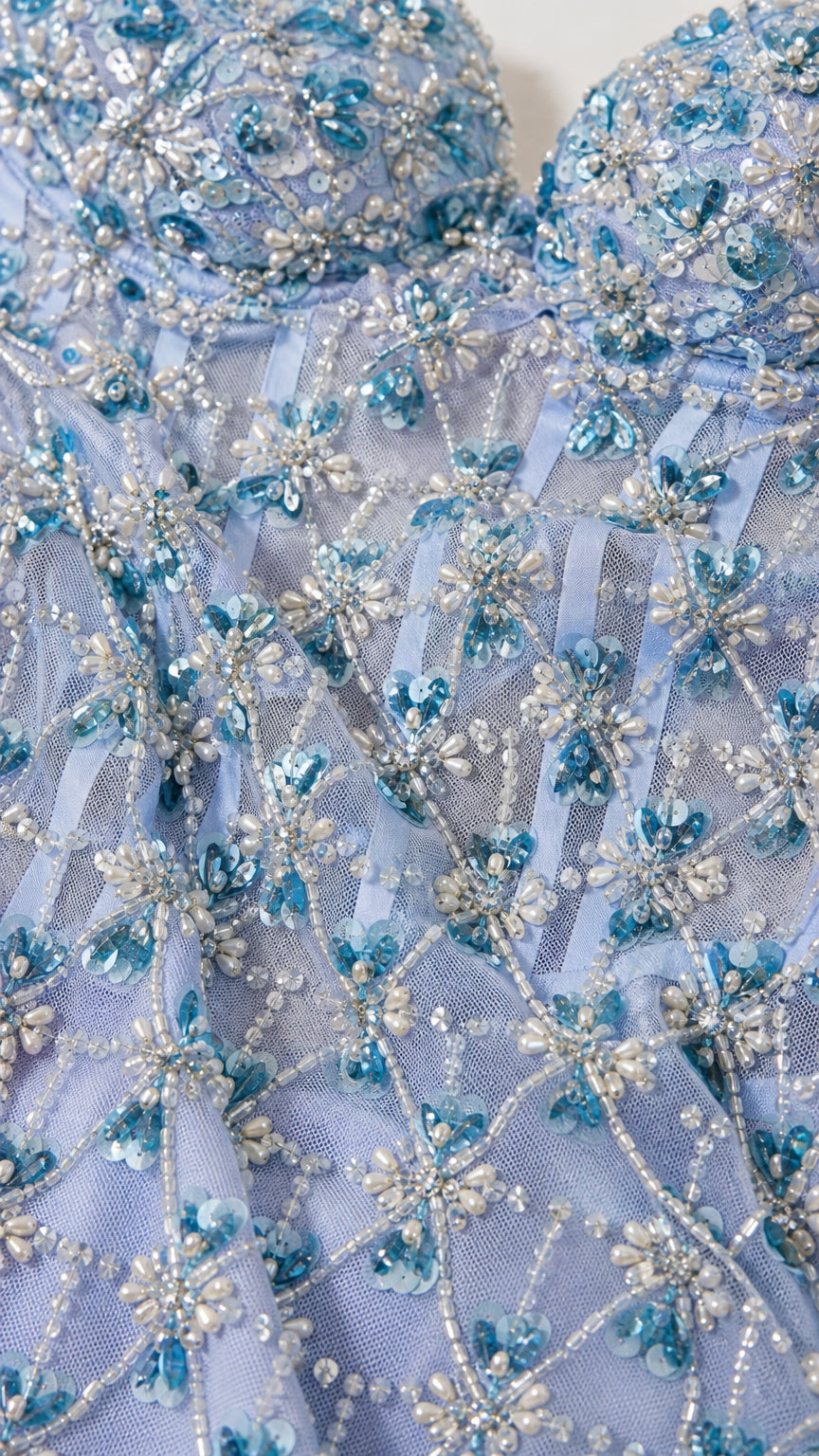 Close-up detail of beaded floral patterns and corset bodice