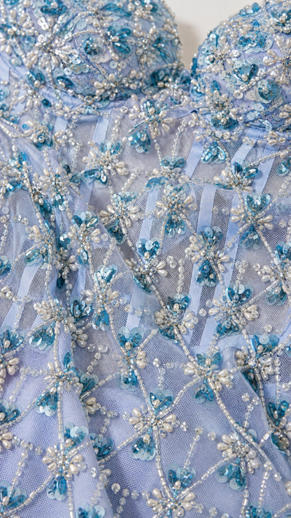 Close-up detail of beaded floral patterns and corset bodice