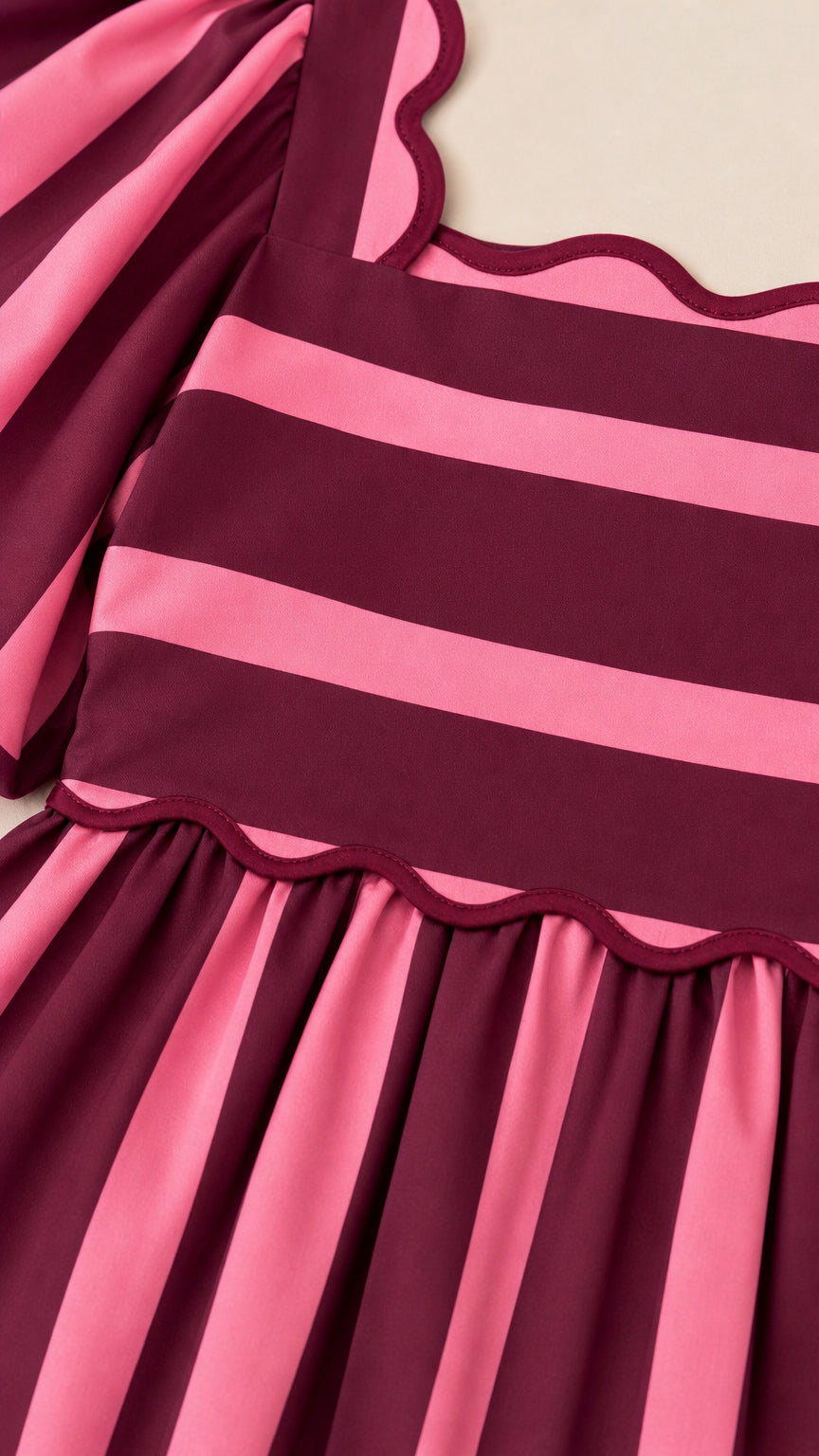 Close up of square neckline and scalloped trim on dress