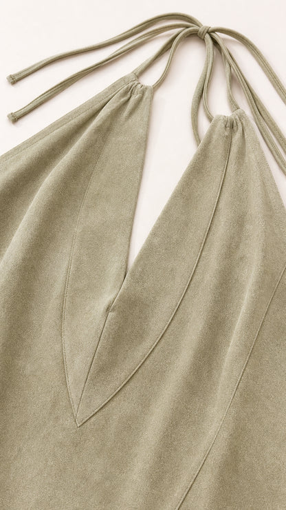 Close-up detail of halter neckline, tie straps, and chevron stitching in Sage Green