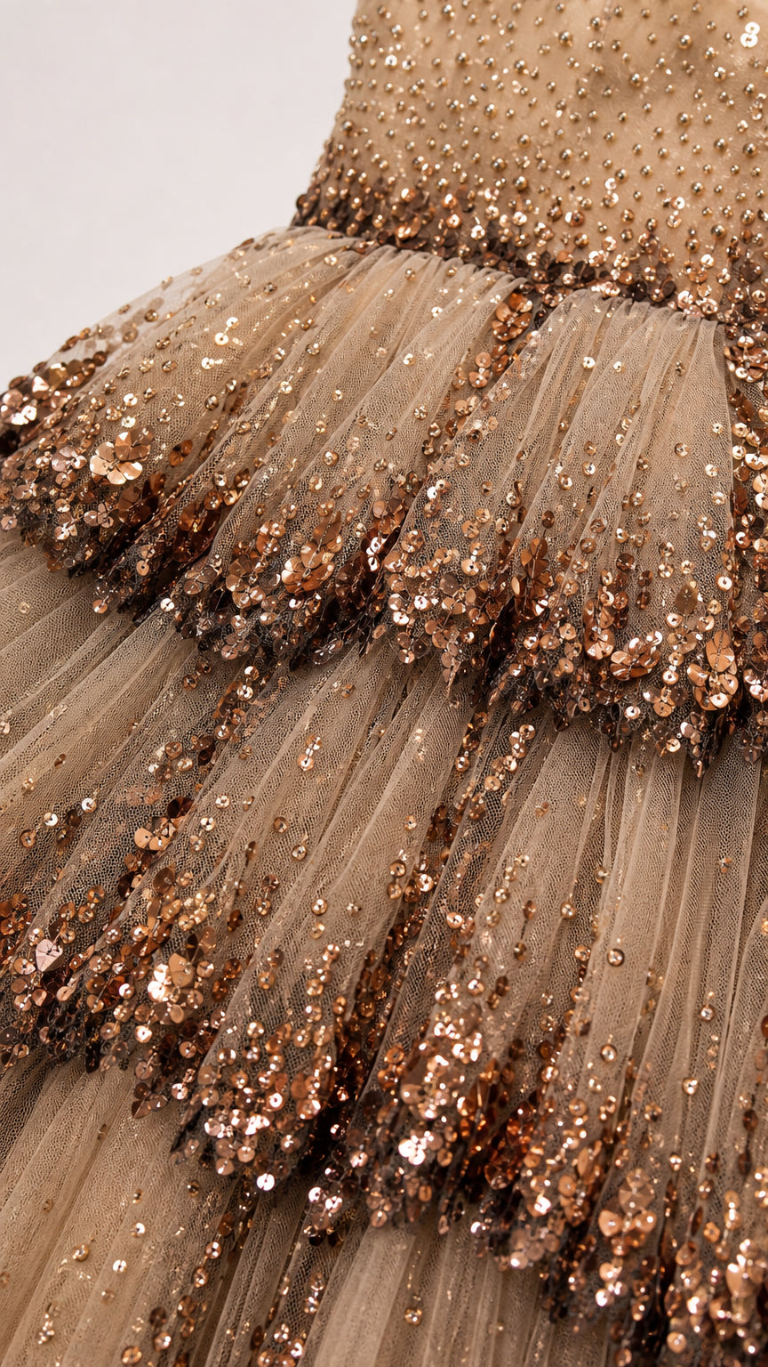Close-up detail of tulle ruffles and sequin embroidery