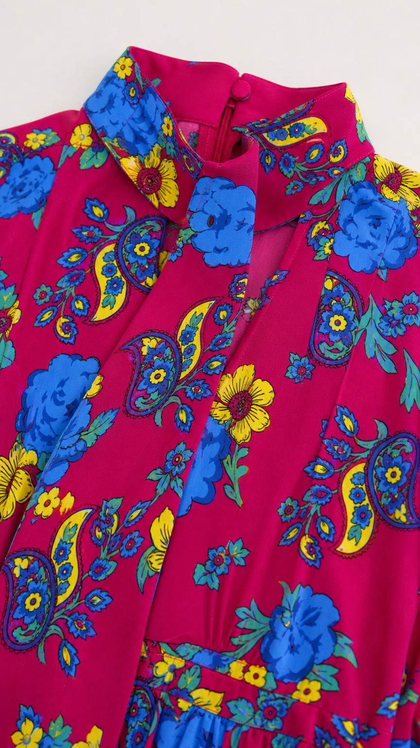 Close up of fuchsia floral dress high neckline and pattern