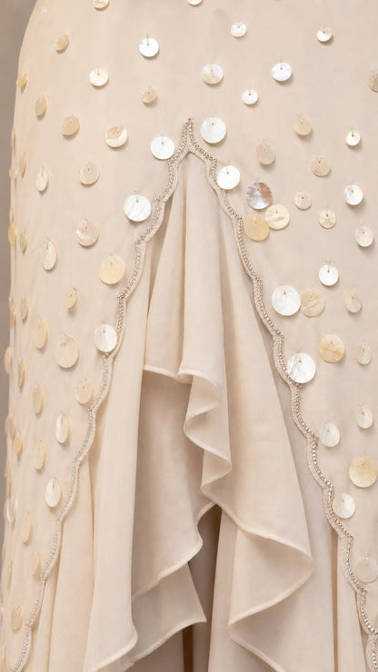 Close-up detail of sequins and ruffle split on White dress