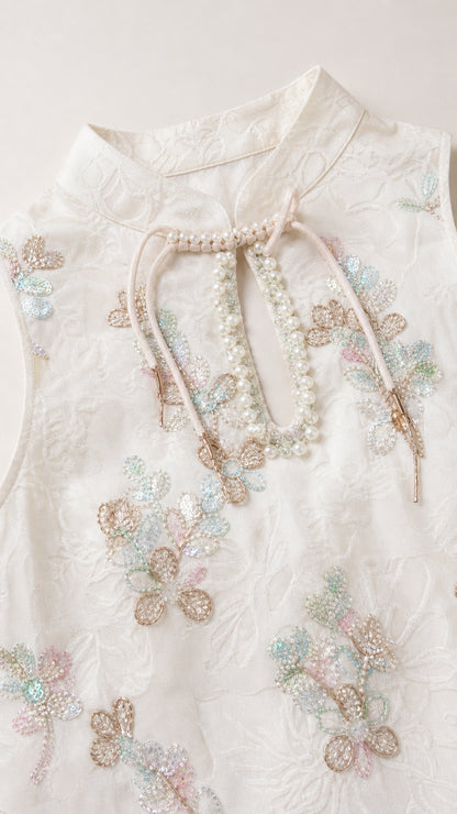 Close-up of mock neck with bead and embroidery details