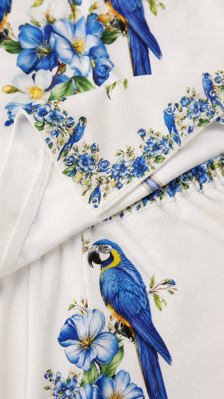 Close-up detail of blue floral and parrot print fabric
