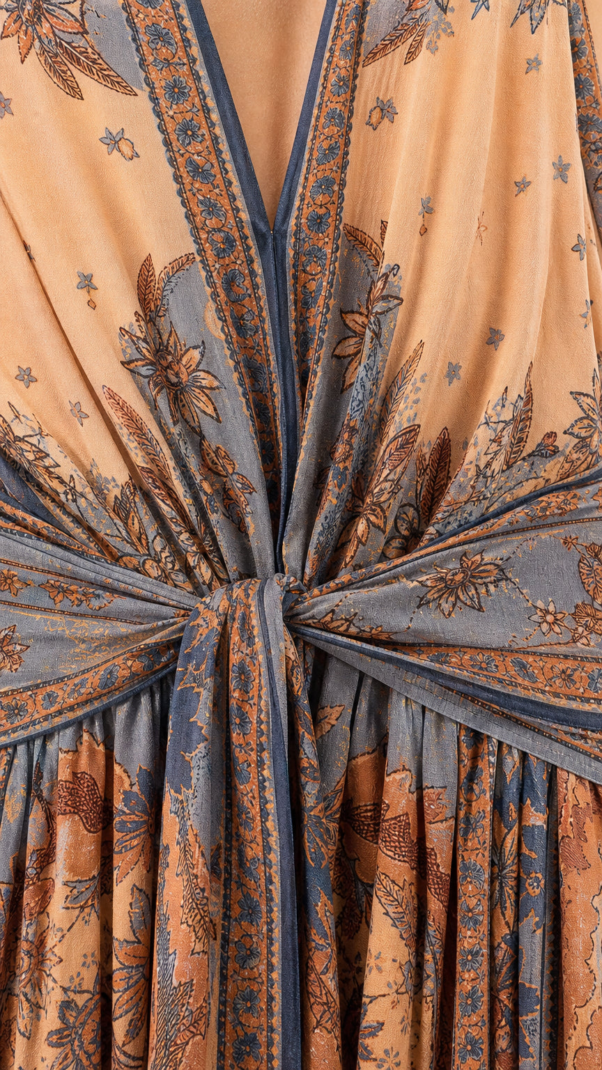 Close-up detail of front knot and print on peach maxi dress