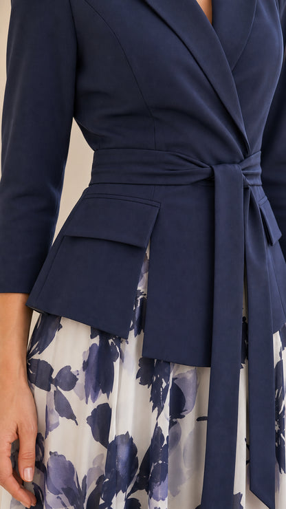 Close-up detail of lapel, pocket flap, and self-tie belt on navy blazer dress