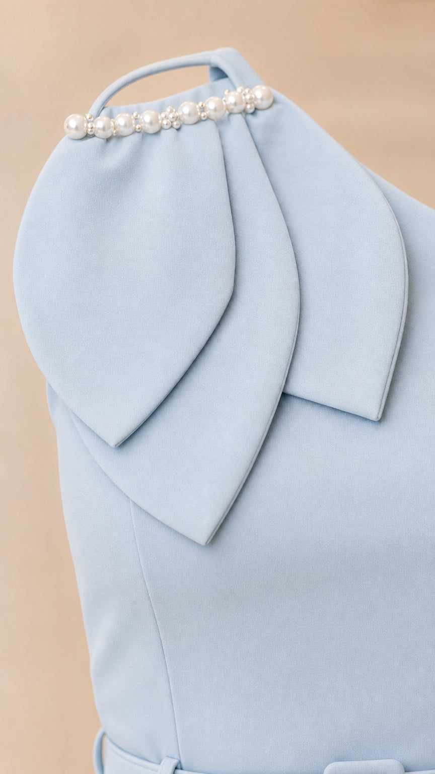 Close-up of shoulder with layered fabric petals and faux pearls