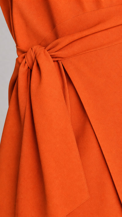 Close-up of the self-tie fabric belt detail on the orange dress