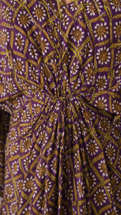 Close up of purple printed fabric and front knot detail