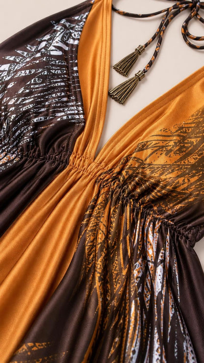 Close-up detail of the gathered V-neckline and tassel ties