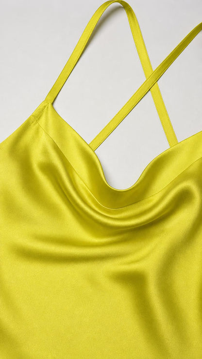 Close-up detail of the cowl neckline and straps on chartreuse satin fabric