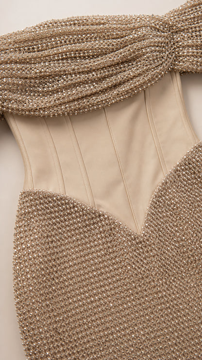 Close-up detail of draped off-shoulder neckline and structured corset waist