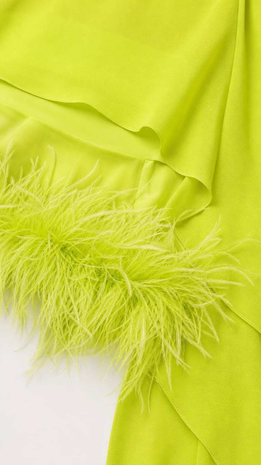 Close-up detail of lime green fabric and feather hem