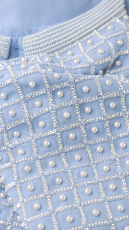 Close-up fabric shot of light blue geometric pearl and bead embellishments