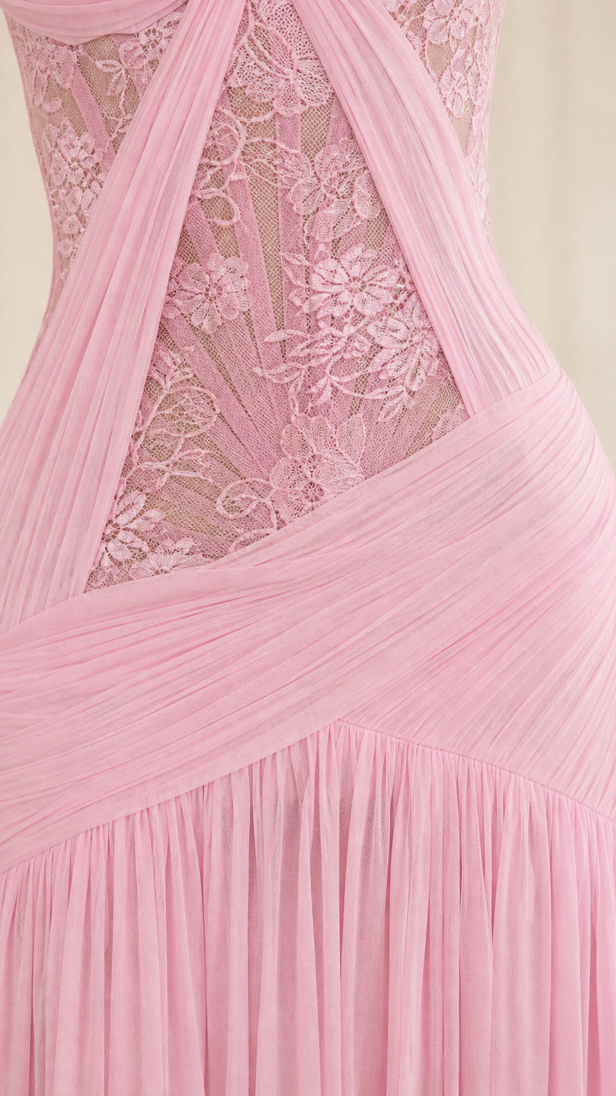 Close-up detail of sheer floral lace bodice and draped chiffon waist