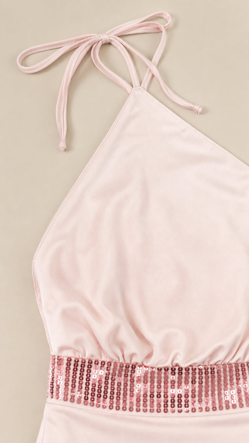 Close-up of halter neckline and sequin waistband