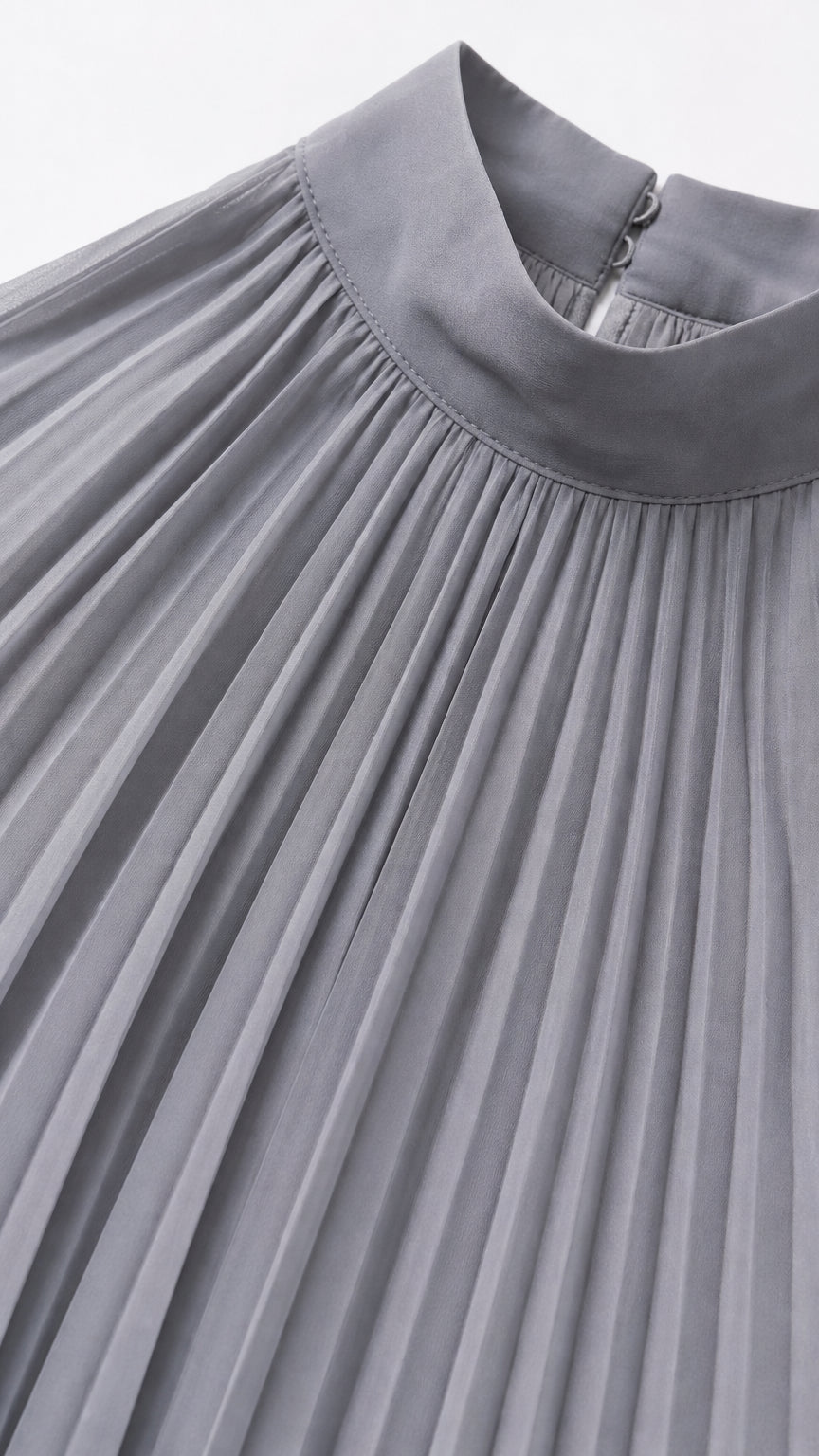 Close-up detail of grey halter neckline and pleating