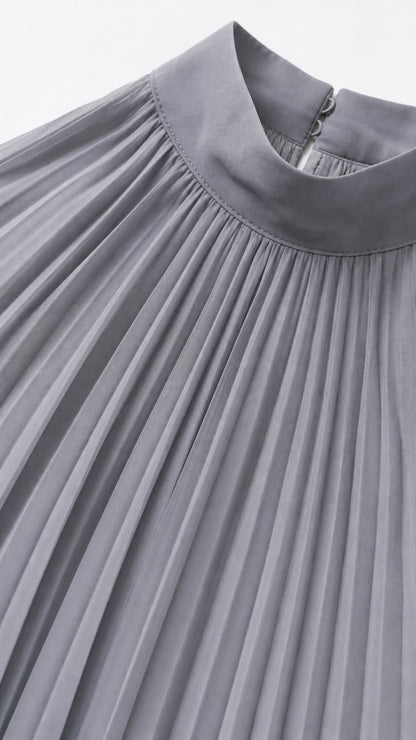 Close-up detail of grey halter neckline and pleating