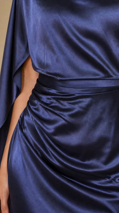 Close-up detail of navy blue satin fabric and ruched waistline tailoring