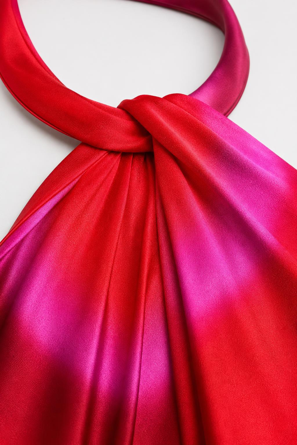 Close up of red tie-dye satin halter neckline knot detail