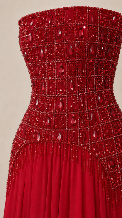 Close-up detail of ruby red crystal and bead embellished corset bodice