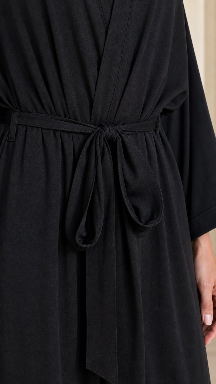 Close-up detail of self-tie fabric belt on Black maxi robe