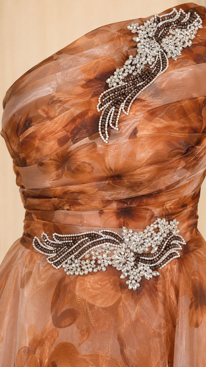 Close-up of crystal applique bodice and shoulder detail on brown gown