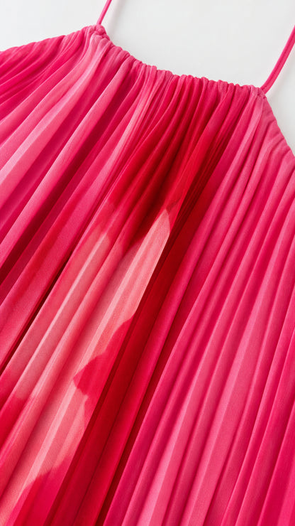 Close-up detail of accordion pleats and halter neckline