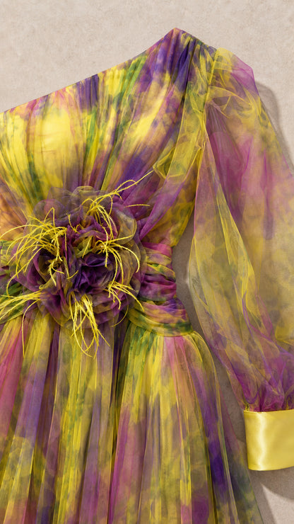 Close-up detail of floral applique and feather waist accent on yellow multi gown
