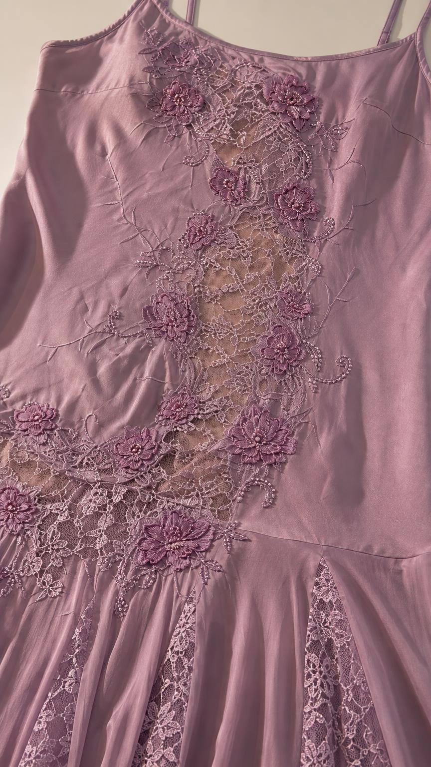 Close-up of floral embroidery and sheer lace panel on dress