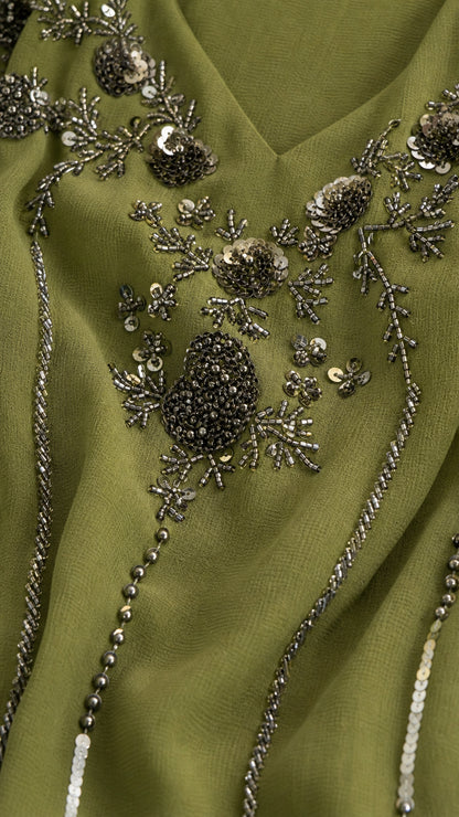 Close-up of intricate bead and sequin embroidery on the neckline