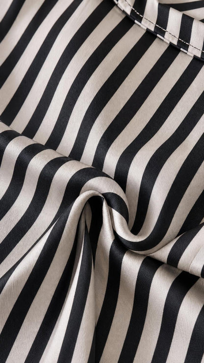 Close-up of smooth-looking black and white striped fabric texture