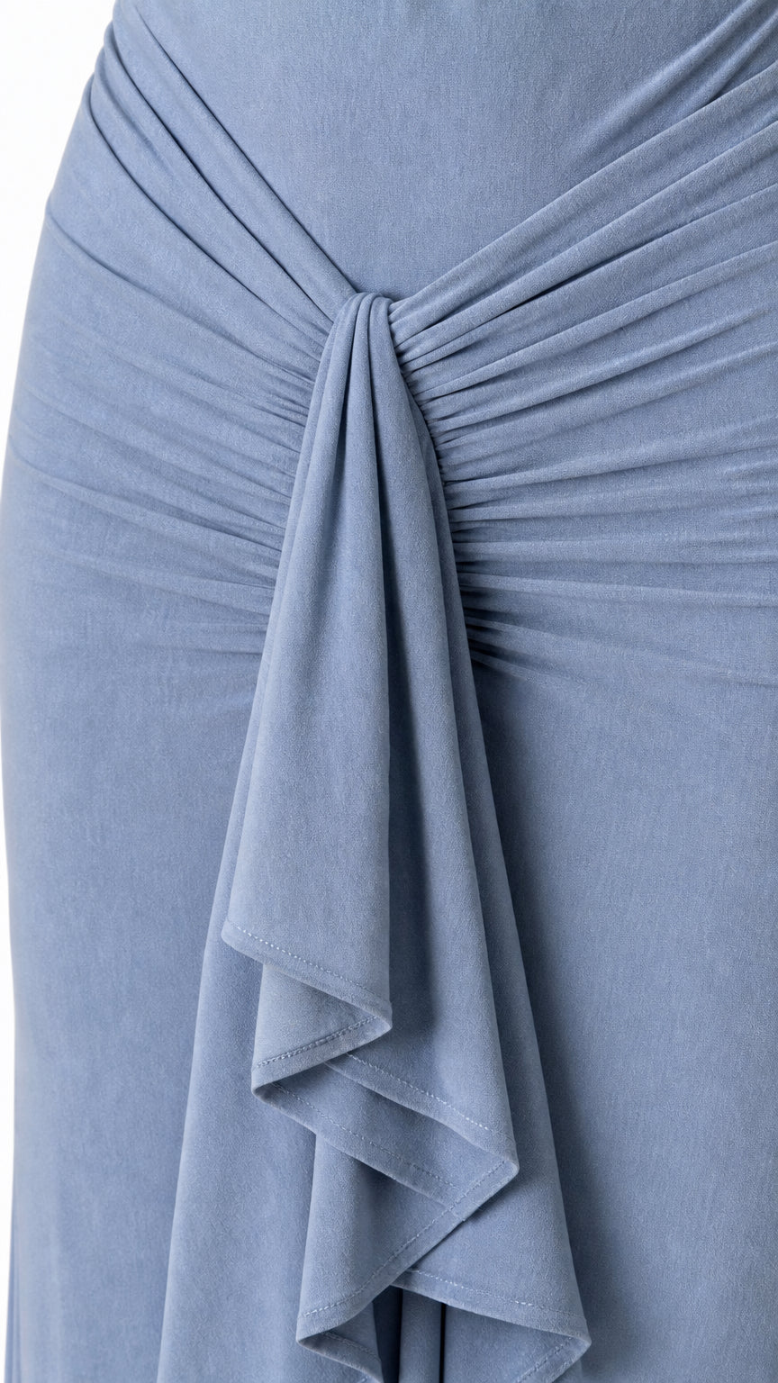 Close-up of front ruched knot and waterfall ruffle on the dress
