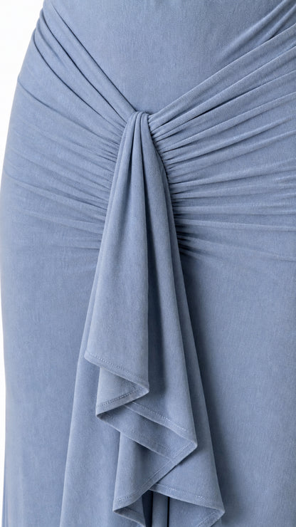 Close-up of front ruched knot and waterfall ruffle on the dress