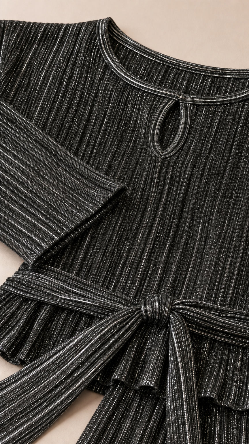 Close-up detail of Charcoal Grey shimmer pleated fabric, keyhole neck, and waist tie