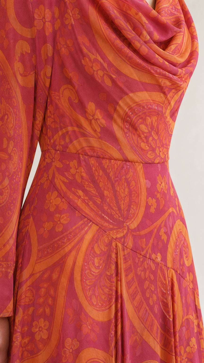 Close-up detail of draped cowl neckline and paisley print