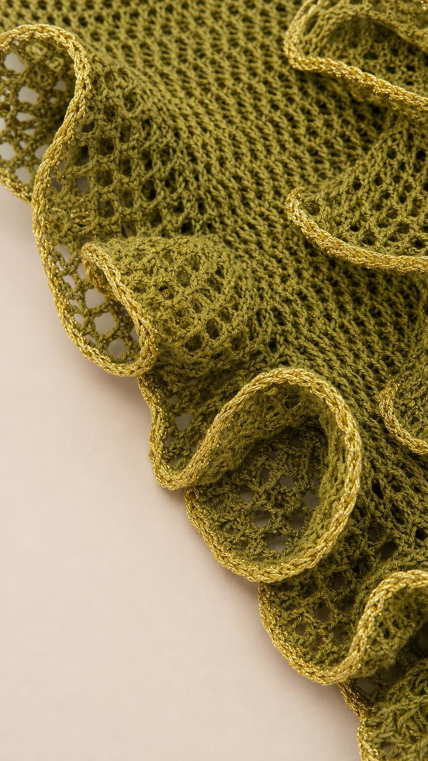 Close up of olive green crochet texture and ruffle trim
