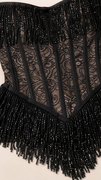 Close-up detail of beaded corset bodice and fringe