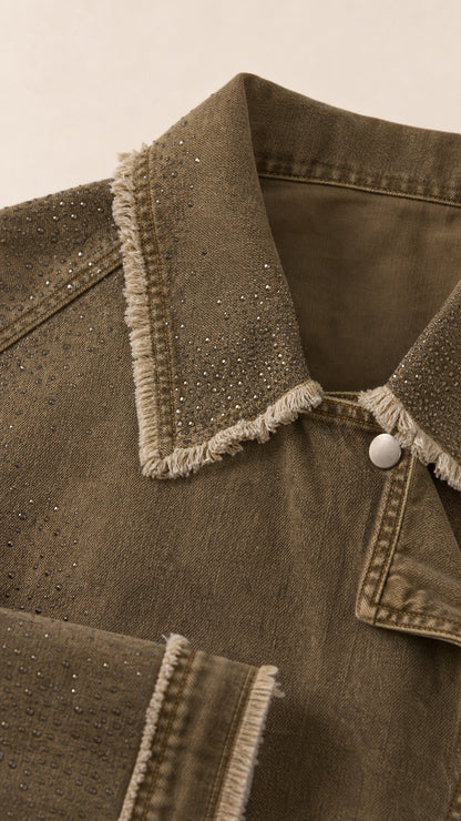 Close-up detail of rhinestone embellishments and frayed collar on twill jacket