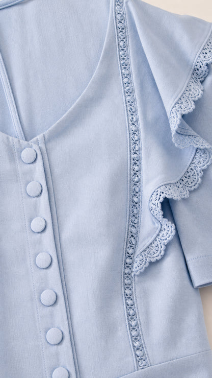 Close-up detail of V-neck, buttons, and lace trim on Light Blue dress