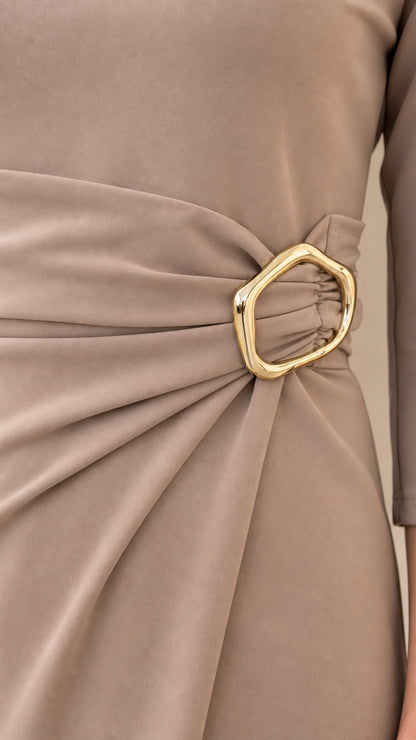 Close-up detail of side waist pleating and organic gold-tone metal buckle