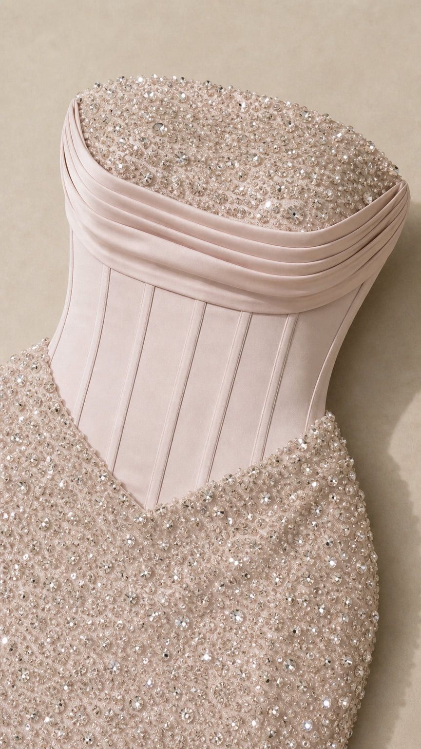Close-up detail of pleated bust, boned corset waist, and shimmering sequin fabric in Champagne